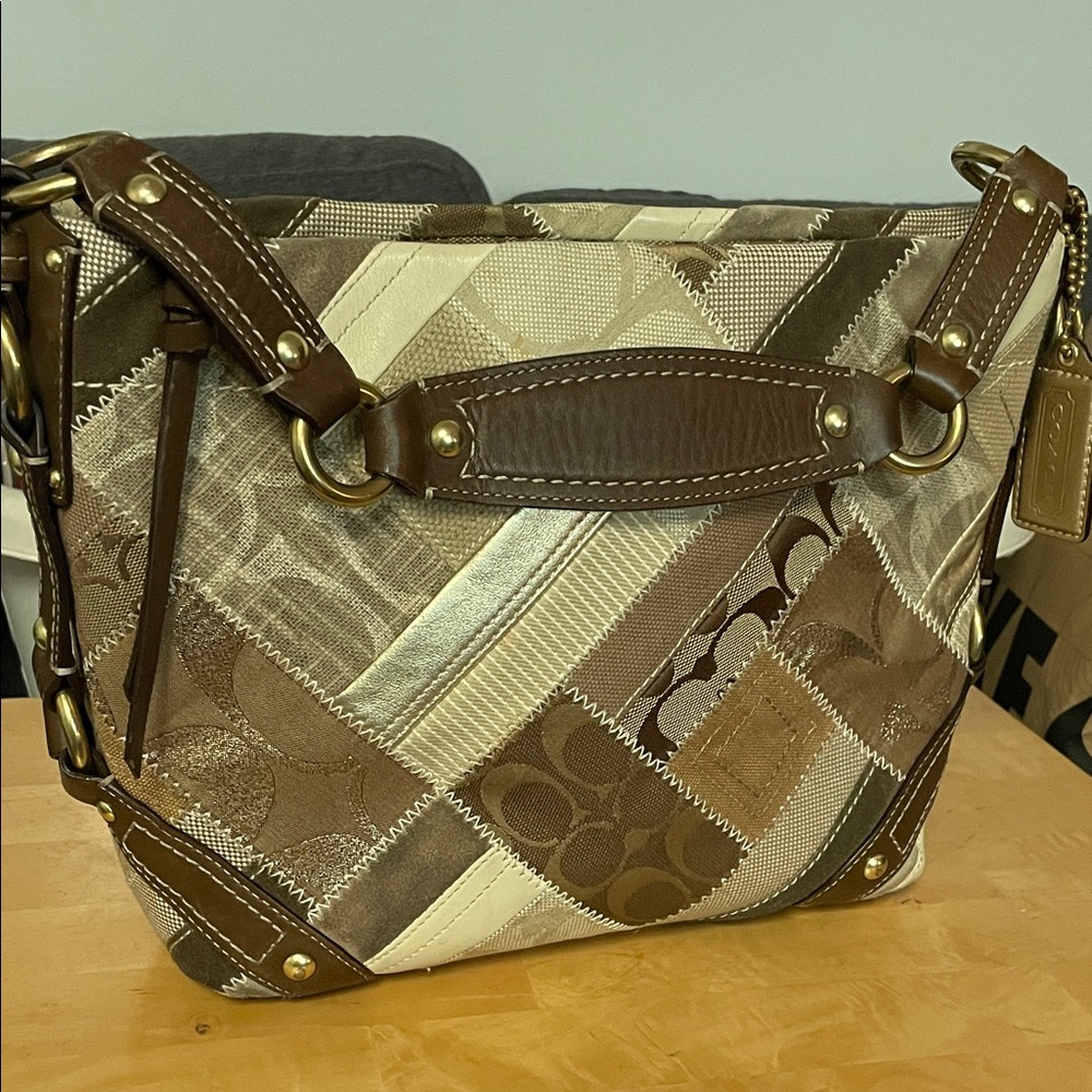 Coach Brown and Cream Patchwork Bag
10 1/4”l x 9 1/4”h x 4 1/2”w